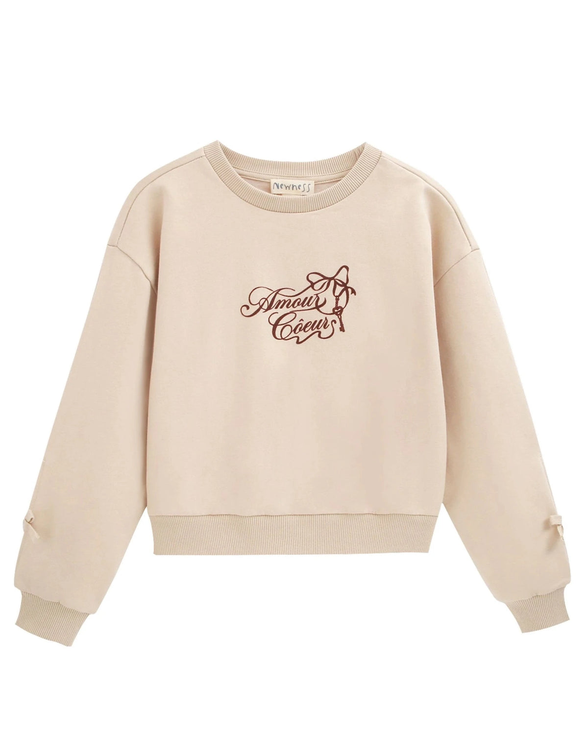 Geborsteld sweatshirt tekst en strikjes op de manchetten